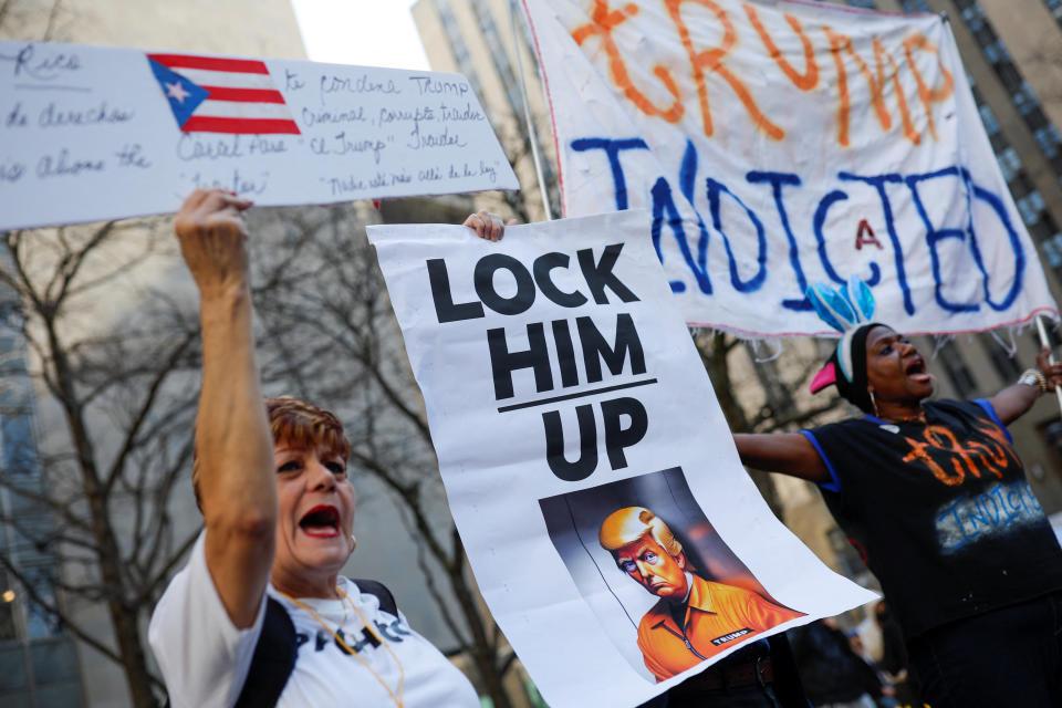 Anti-Trump protesters, with a sign that reads Lock Him Up, outside the courthouse. 