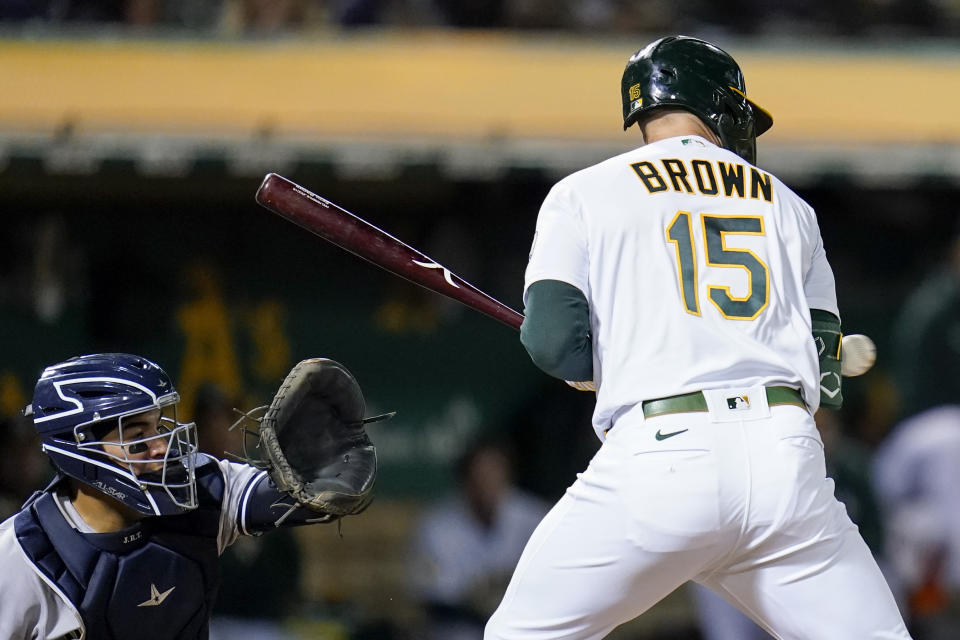 Oakland Athletics' Seth Brown (15) is hit by a pitch with the bases loaded during the seventh inning of a baseball game against the New York Yankees in Oakland, Calif., Thursday, Aug. 25, 2022. Skye Bolt scored on the play. (AP Photo/Godofredo A. Vásquez)