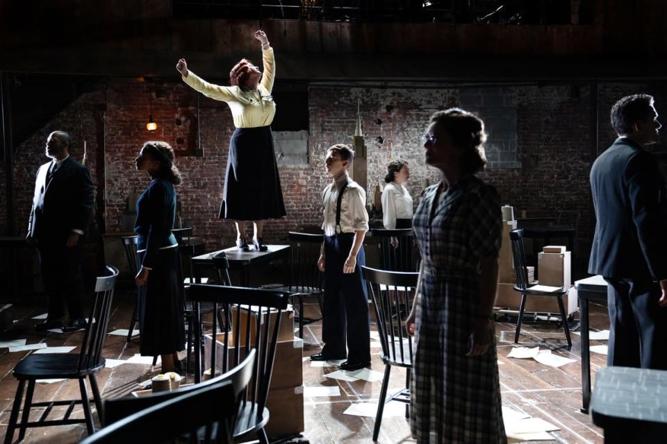 Julia Lester as Miss Marmelstein, standing on table, with the company of “I Can Get It for You Wholesale.”