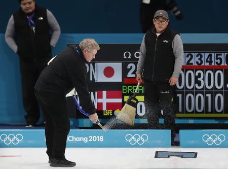 Curling - Pyeongchang 2018 Winter Olympics - Men's Round Robin - Gangneung Curling Center - Gangneung, South Korea - February 20, 2018 - The ice master Hans Wuthrich works on the curling sheet during the break in the games. REUTERS/Cathal McNaughton