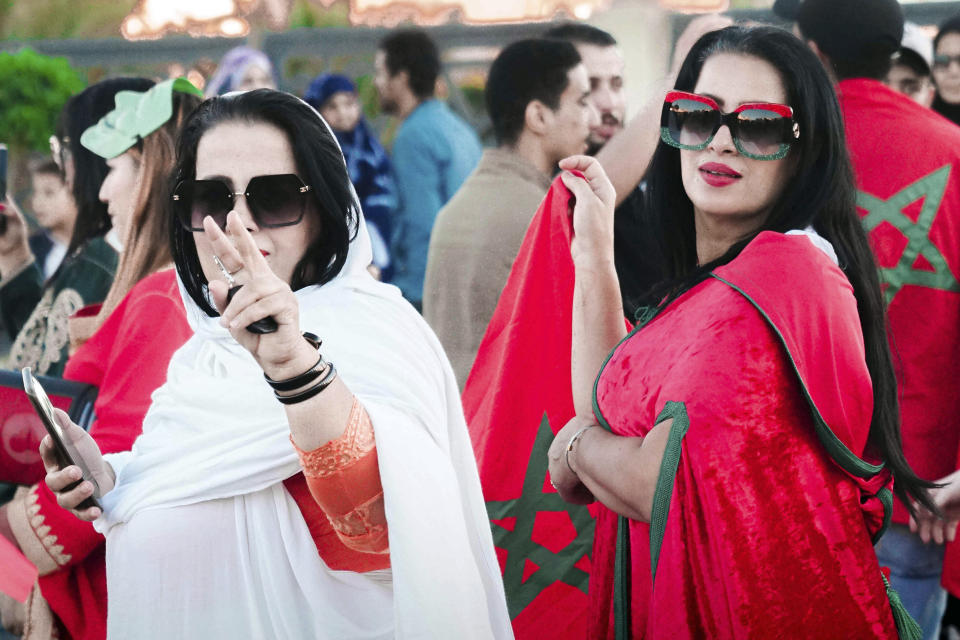 Women wearing a Sahrawis traditional outfit celebrate Morocco's World Cup victory against Portugal in the Morocco-administered Western Sahara city of Laayoune, Saturday, Dec. 10, 2022. (AP Photo/Noureddine Abakchou)