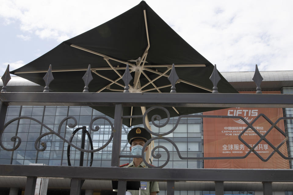 A paramilitary policeman stands guard outside a trade fair in Beijing on Friday, Sept. 4, 2020. China's Ministry of Commerce on Saturday, Sept. 19 2020 issued regulations for its "unreliable entity" list, aimed at foreign companies it says endanger its national sovereignty, security or development interests. (AP Photo/Ng Han Guan)