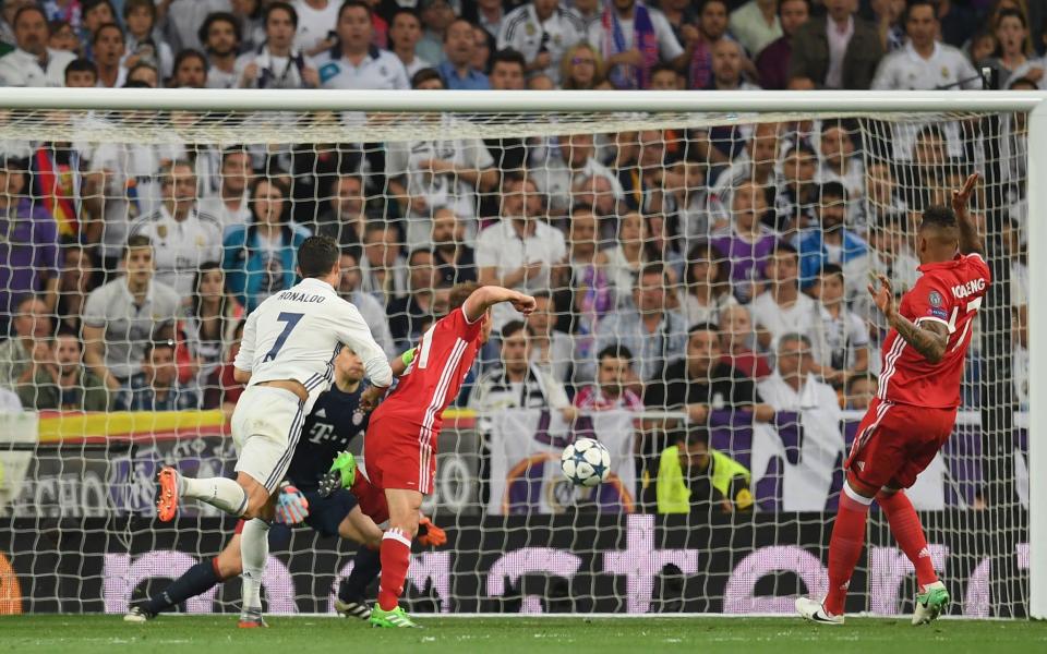 Cristiano Ronaldo of Real Madrid scores his sides first goal past Manuel Neuer  - Credit: GETTY