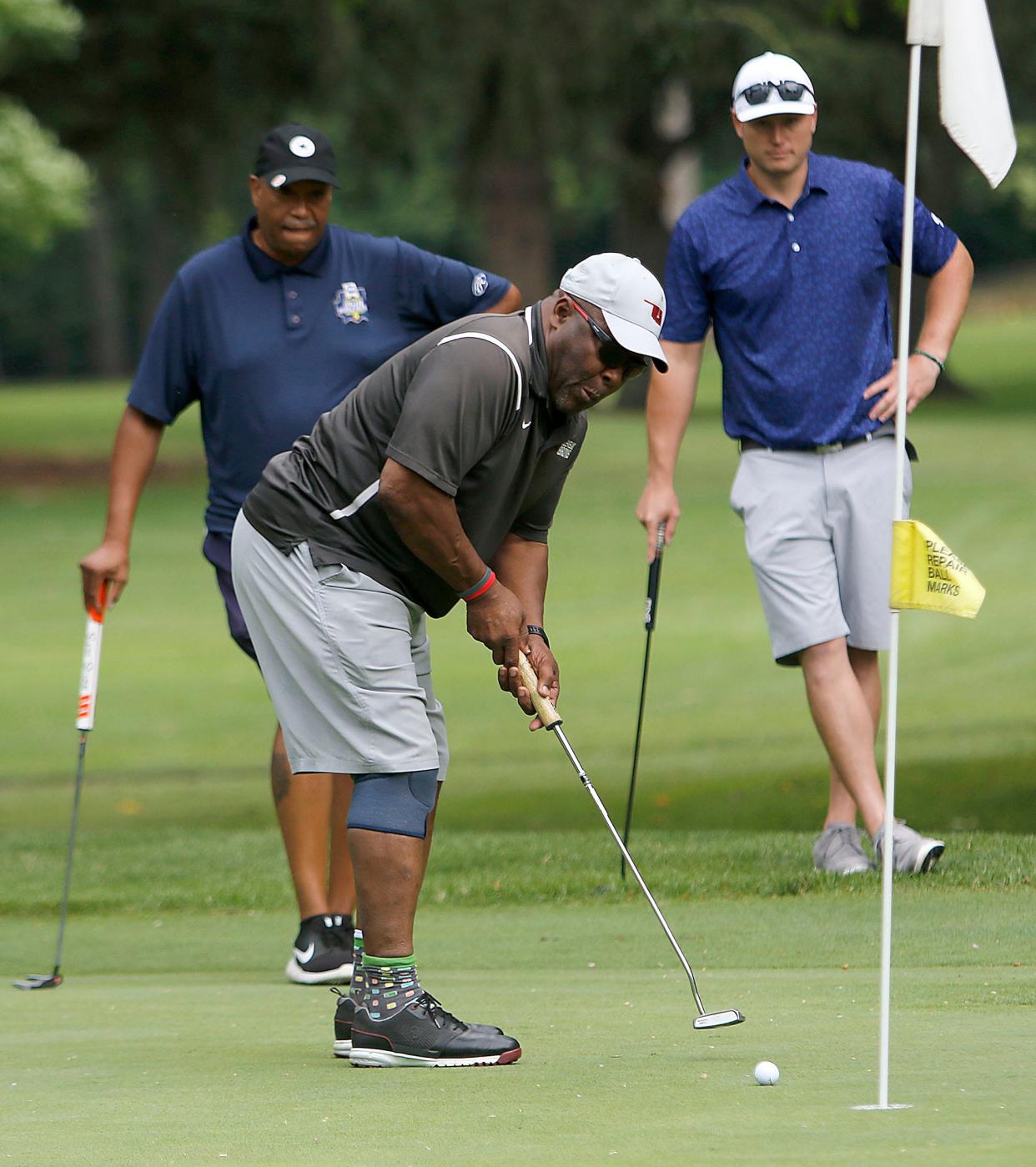 Former Cleveland Browns running back Greg Pruitt putts as Tony Roseborough and Tyler Eversole watch at the Wendy's Golf Classic Friday, June 25, 2021 at the Ashland Golf Club. TOM E. PUSKAR/TIMES-GAZETTE.COM