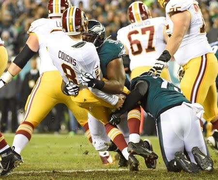 Dec 26, 2015; Philadelphia, PA, USA; Philadelphia Eagles defensive end Fletcher Cox (91) and defensive end Cedric Thornton (72) hit Washington Redskins quarterback Kirk Cousins (8) during the second quarter at Lincoln Financial Field. Mandatory Credit: Eric Hartline-USA TODAY Sports