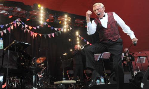 Sir Bruce Forsyth, striking a familiar pose, at Glastonbury in 2013.