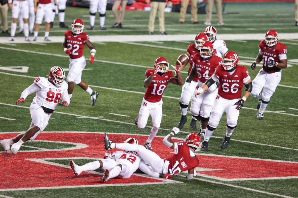 Rutgers Scarlet Knights wide receiver Bo Melton (18) receives a lateral pass from tight end Matt Alaimo (10) as Indiana Hoosiers defensive lineman Jerome Johnson (98) defends during the fourth quarter at SHI Stadium. The touchdown scored on the play was called back for a forward lateral penalty.