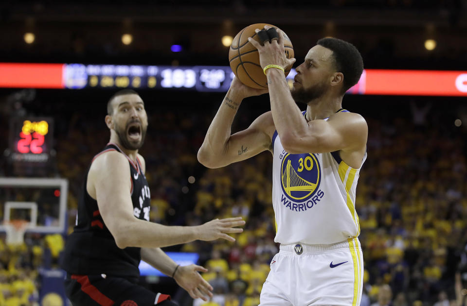 Golden State Warriors guard Stephen Curry (30) shoots in front of Toronto Raptors center Marc Gasol during the second half of Game 3 of basketball's NBA Finals in Oakland, Calif., Wednesday, June 5, 2019. (AP Photo/Ben Margot)