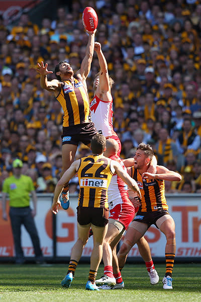 <p>Hawthorn's Cyril Rioli soars above the pack.</p>