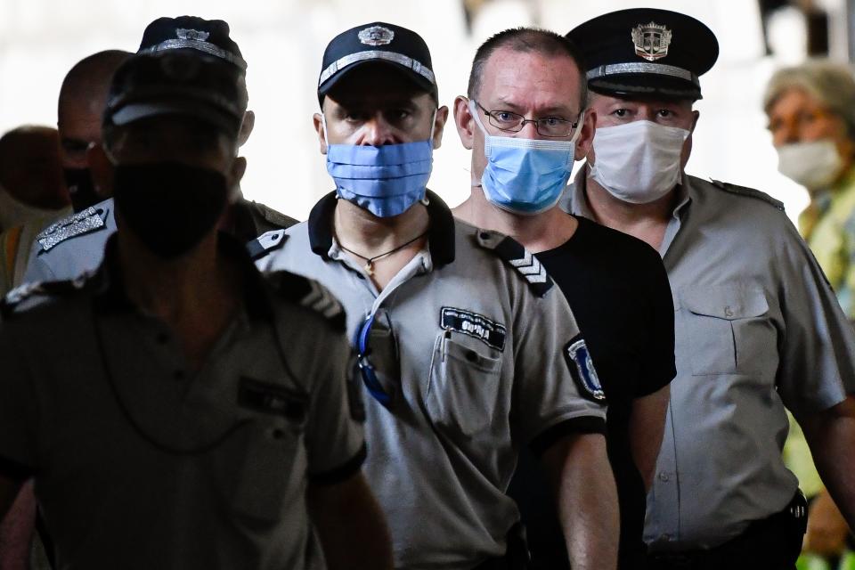British suspect Daniel Erickson-Hull (2nd-R) is escorted into court in the city of Sliven, on July 17, 2020. - The trial of a British man convicted in the UK of possessing child pornography opened in Bulgaria Friday on charges of sexually abusing eight underage boys in a poor Roma community. Their families have refused to press for civil damages, however. Daniel Erickson-Hull, 44, was detained last September in the central town of Sliven, where he was a self-proclaimed evangelical preacher. (Photo by NIKOLAY DOYCHINOV / AFP) (Photo by NIKOLAY DOYCHINOV/AFP via Getty Images)