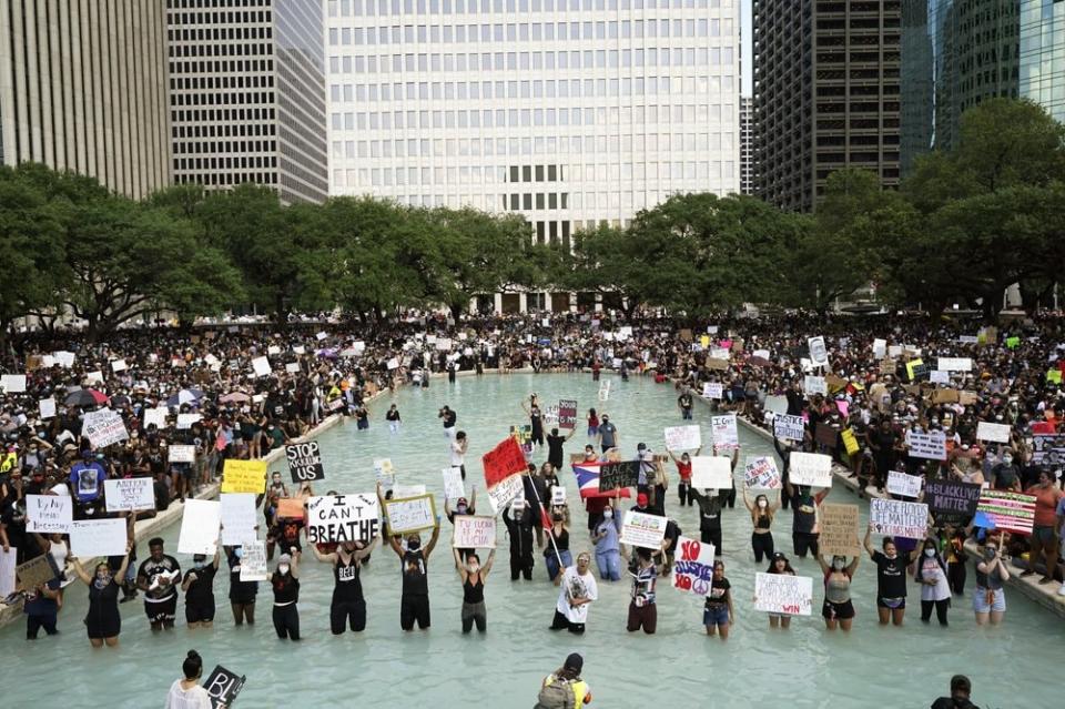 In this June 2, 2020, file photo people rally to protest the death of George Floyd in Houston. (AP Photo/David J. Phillip, File)