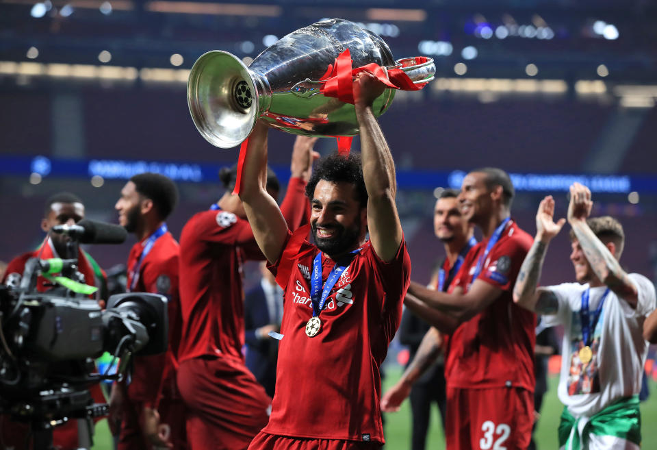 Liverpool's Mohamed Salah celebrates with the trophy after winning the UEFA Champions League Final at the Wanda Metropolitano, Madrid.