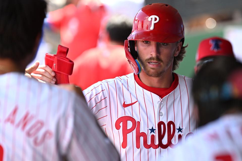 Philadelphia Phillies second baseman Bryson Stott (5) celebrates with his teammates after scoring a run in the first inning of the spring game against the Toronto Blue Jays at BayCare Ballpark.