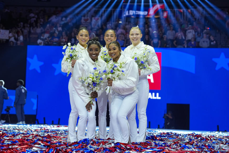 The U.S. women's team from left to right, Suni Lee, Simone Biles, Hezly Rivera, Jordan Chiles and Jade Carey, smile after being named to the 2024 Olympic team at the United States Gymnastics Olympic Trials on Sunday, June 30, 2024, in Minneapolis. (AP Photo/Charlie Riedel)