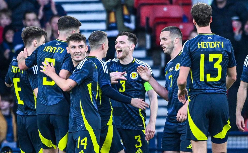 scotland football players celebrate a goal