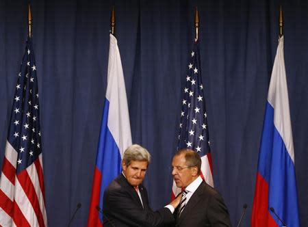 U.S. Secretary of State John Kerry and Russian Foreign Minister Sergei Lavrov (R) shake hands after making statements following meetings regarding Syria, at a news conference in Geneva September 14, 2013. REUTERS/Ruben Sprich