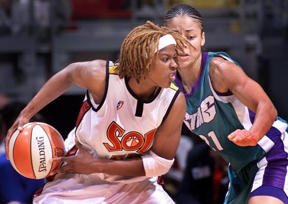 A determined Miami SOL’s Sheri Sam attempts to get around Charlotte Sting defender Allison Feaster in a game from Aug. 14, 2001.