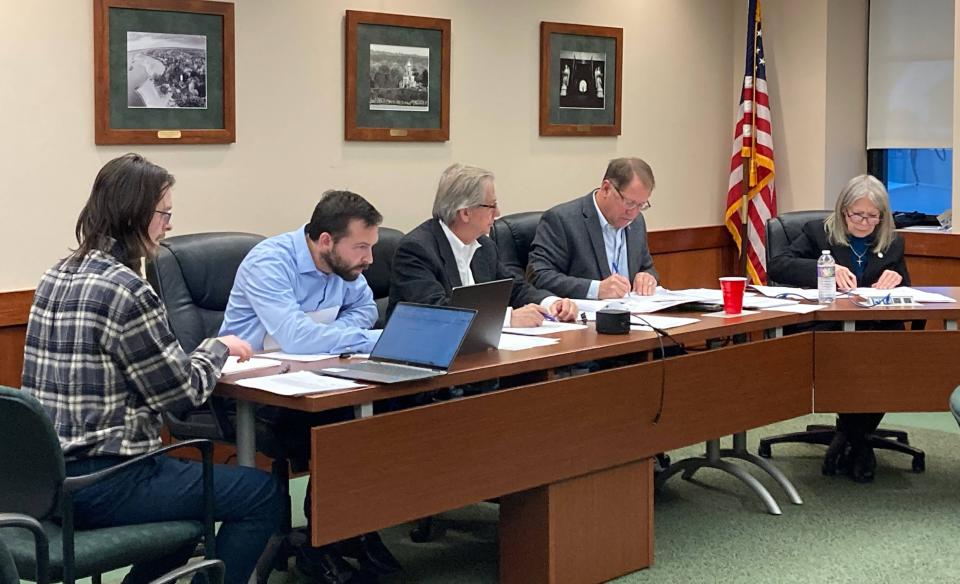 Members of Erie County Council organize action sheets prior to a Nov. 28 budget meeting. From left are Bonus Accounting accountants Colin Domowicz and Kenny Bonus; Council Solicitor Tom Talarico; and council members Jim Winarski and Ellen Schauerman.