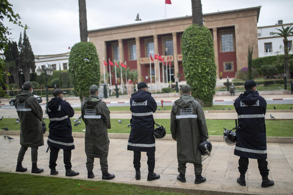 Security forces stand guard to prevent a protest against the normalization deal between Morocco and Israel, in Rabat, Morocco, Monday, Dec. 14, 2020. Moroccan authorities on Monday dispersed a group of pro-Palestine activists who attempted to stage a protest outside Parliament building in the capital Rabat to denounce the kingdom’s recent normalization of relations with Israel. (AP Photo/Mosa'ab Elshamy)