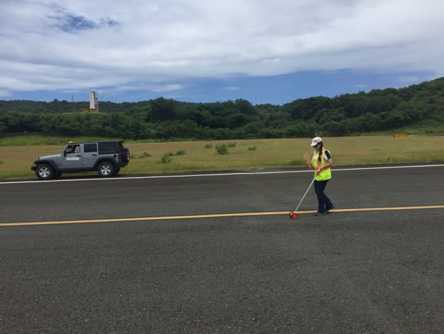 Velez-Vega inspecting an airport runway’s pavement.