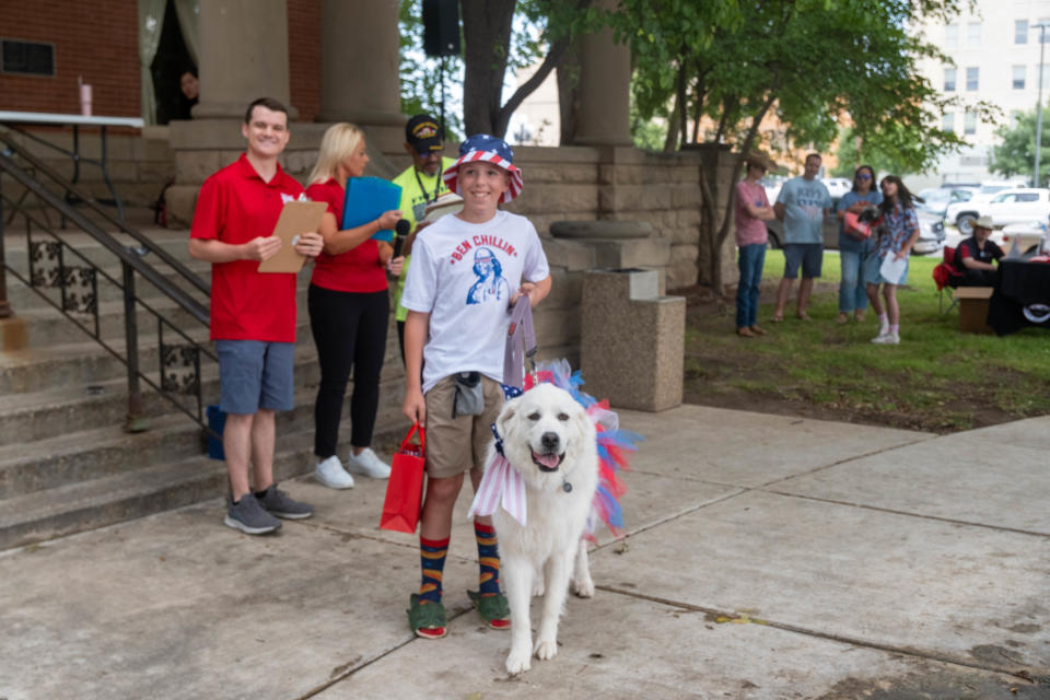 Colton Steinle shows off best smile winner Pearl at Center City's 3rd annual Patriotic Pet Parade Saturday at the Amarillo Community Market in downtown Amarillo.