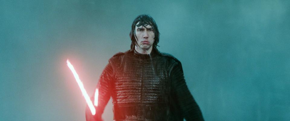 Kylo Ren holding his iconic lightsaber in "Star Wars"
