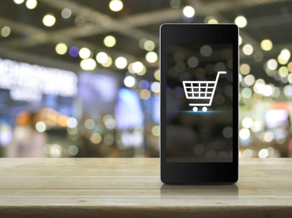 A shopping cart icon on a smartphone.