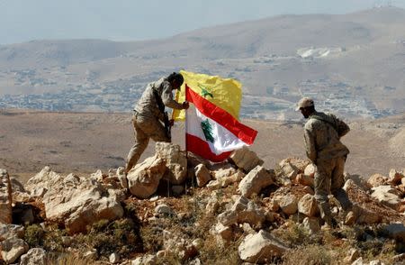 Hezbollah fighters put Lebanese and Hezbollah flags at Juroud Arsal, Syria-Lebanon border, July 25, 2017. REUTERS/Mohamed Azakir