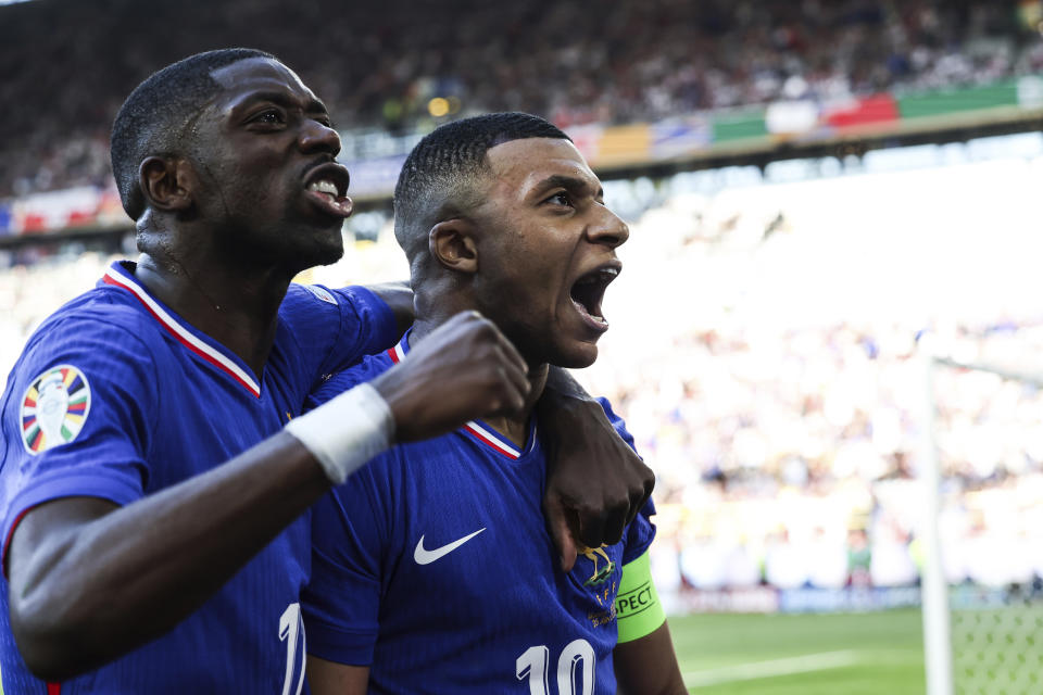 FILE -Kylian Mbappe of France, right, celebrates after scoring a penalty kick during a Group D match between the France and Poland at the Euro 2024 soccer tournament in Dortmund, Germany, Tuesday, June 25, 2024. Cristiano Ronaldo vs. Kylian Mbappe is not just a clash of soccer icons but a clash of generations. They’ll go head to head when Portugal plays France in the Euro 2024 quarterfinals on Friday and their heavyweight meeting just got a little bit bigger after Ronaldo said this would be his last European Championship.(Friso Gentsch/dpa via AP, File)