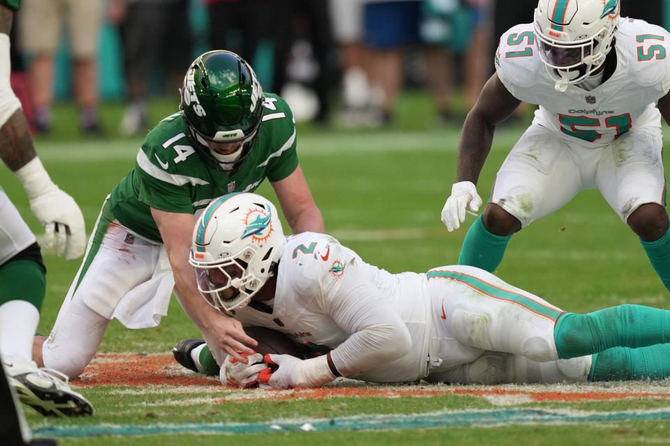 Miami Dolphins linebacker Bradley Chubb (2) recovers a fumble after knocking the ball loose from New York Jets quarterback Trevor Siemian (14) during the second half of an NFL game at Hard Rock Stadium in Miami Gardens, Dec. 17, 2023.