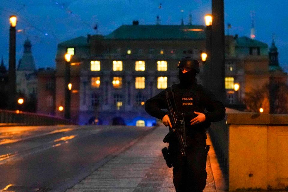 A police officer walks across a bridge over the Vltava river in downtown Prague, Czech Republic on Thursday (Copyright 2023 The Associated Press. All rights reserved)