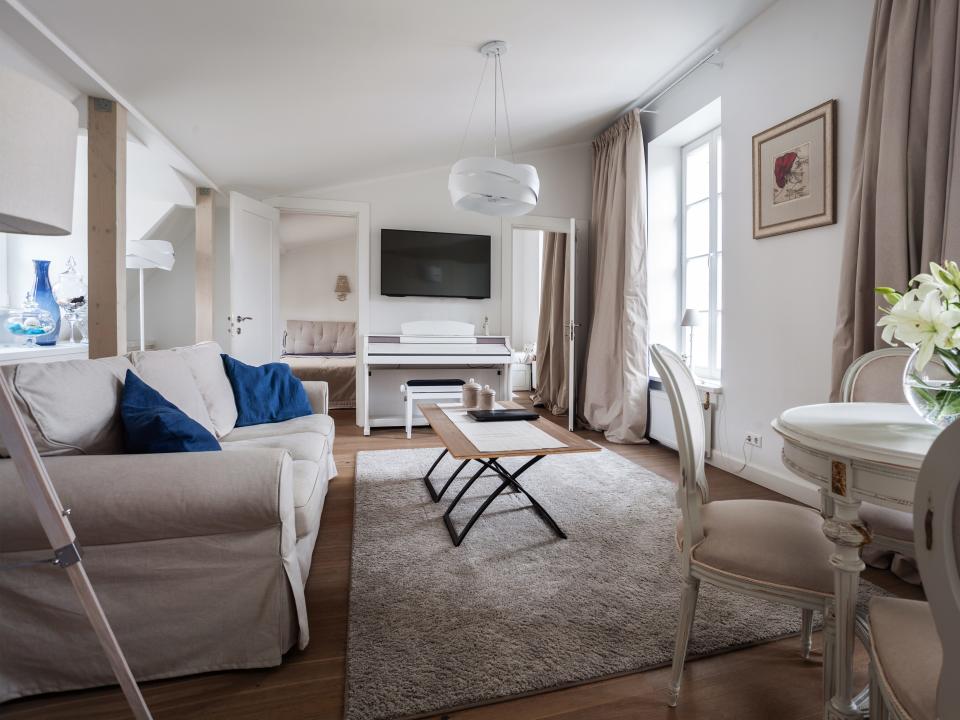 Living room with white shabby chic sofa, coffee table, and TV