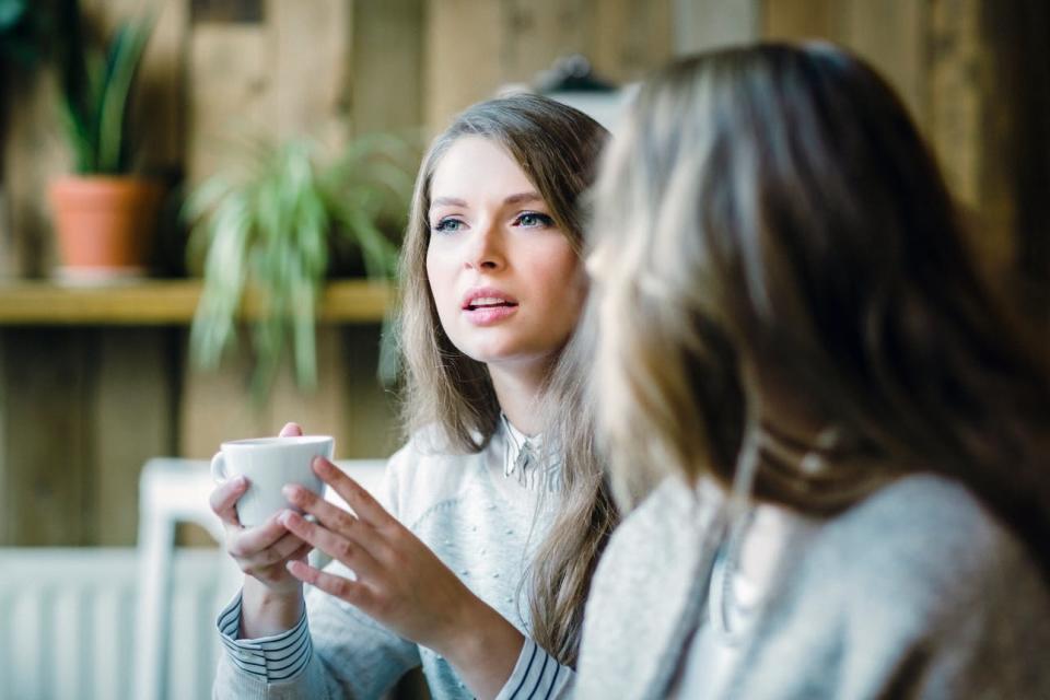 A woman has coffee with a friend