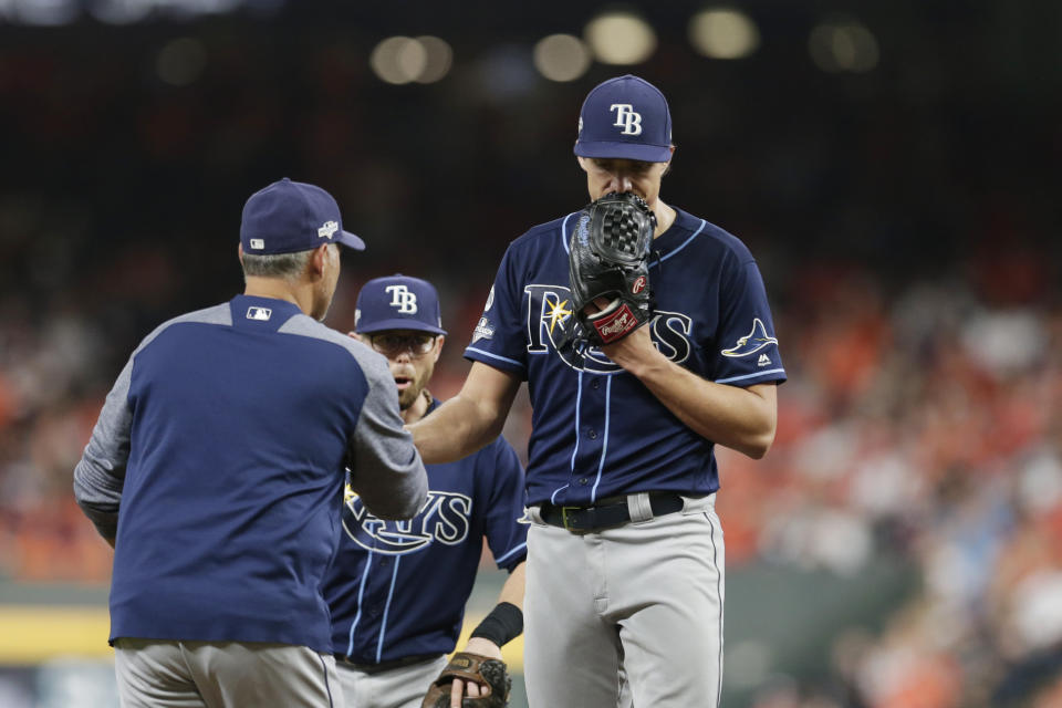 Tampa Bay Rays starting pitcher Tyler Glasnow, right, is pulled during the third inning of Game 5 of the baseball team's American League Division Series against the Houston Astros in Houston, Thursday, Oct. 10, 2019. (AP Photo/Michael Wyke)