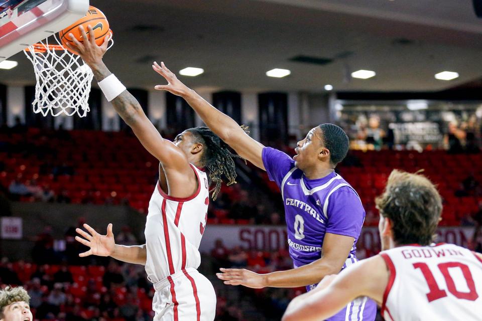 Oklahoma guard Otega Oweh (3) lays up the ball past Central Arkansas forward UbongAbasi Etim (0) in the second half during an NCAA game between the Oklahoma Sooners and the Central Arknasaw Bears at the Lloyd Noble Center in Norman, Okla., on Thursday, Dec. 28, 2023.