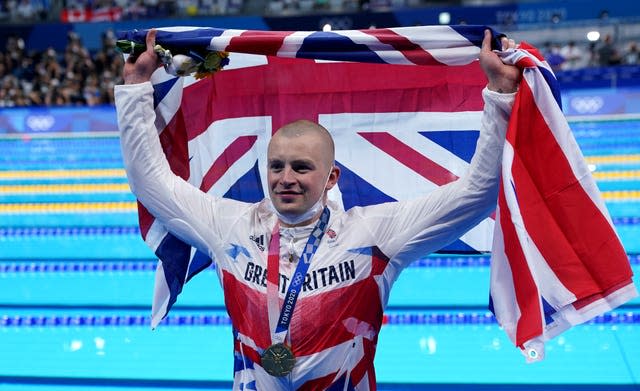 Adam Peaty poses with his gold medal in Tokyo 