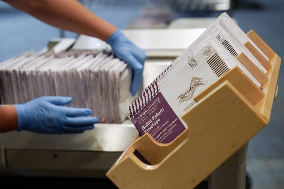 FILE - In this Nov. 1, 2020, file photo, envelopes containing ballots are shown at a San Francisco Department of Elections at a voting center in San Francisco. Californians will start receiving ballots next month asking if Gov. Gavin Newsom, a Democrat should be recalled and if so, who they want to vote for to replace him. (AP Photo/Jeff Chiu, File)