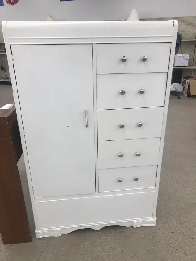 A before image of a large cabinet covered in white paint