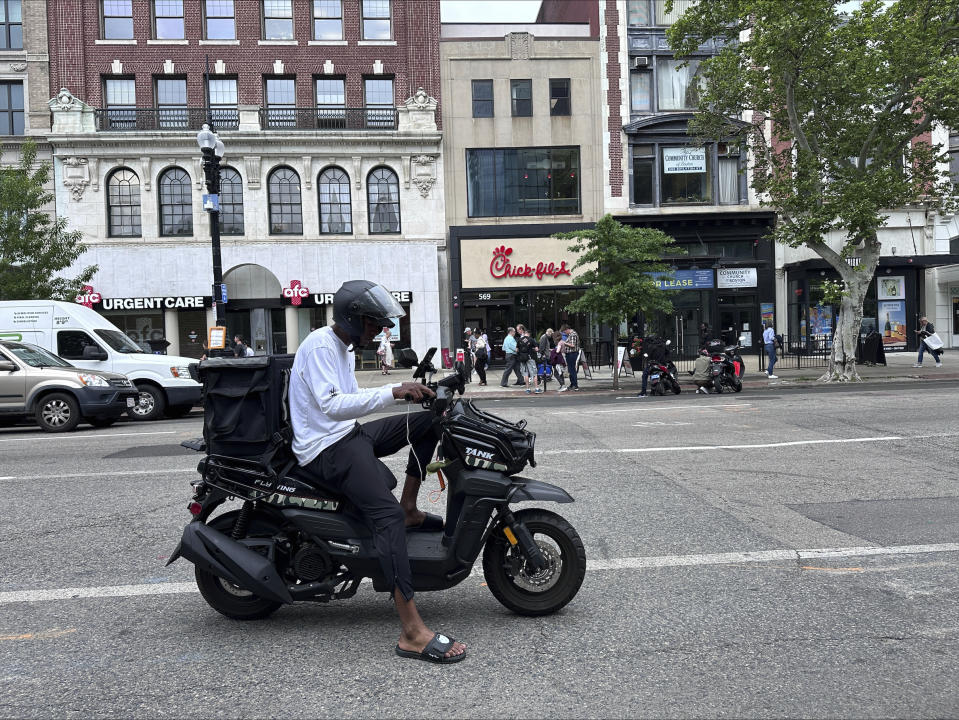 Delivery scooters are parked as drivers wait to pick up food for delivery, Thursday, June 6, 2024, in Boston. Boston and New York are cracking down on unlawful drivers, whom they say are ignoring traffic laws and making city streets more dangerous. (AP Photos/Michael Casey)