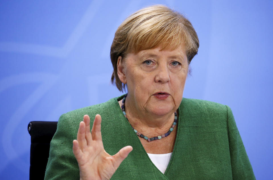 German Chancellor Angela Merkel addresses the media following a meeting with leaders of the 16 federal states to discuss the country's response following the spread of the coronavirus, at the Chancellery in Berlin, Thursday, Aug. 27, 2020. In an effort to harmonize different coronavirus measures across the country, Germany will implement a nationwide fine for people not wearing face masks and also ban mass events until the end of the year, Chancellor Angela Merkel said Thursday. (Michele Tantussi/Pool Photo via AP)