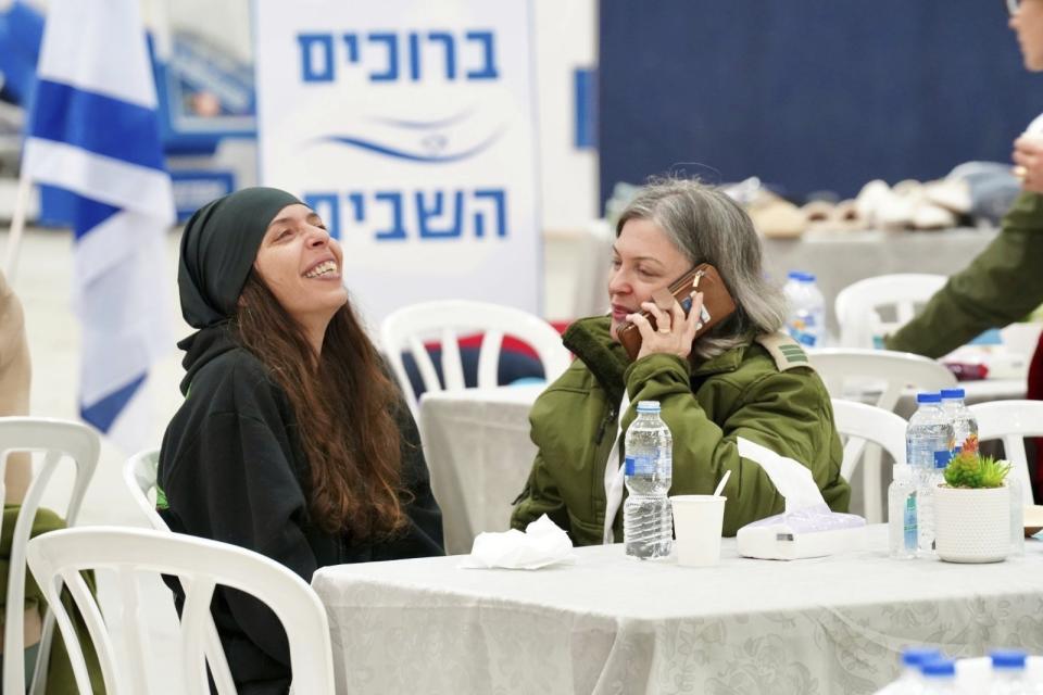 This handout photo provided by the IDF on Thursday, Nov. 30, 2023, shows released Israeli hostage Moran Stela Yanai, left, upon her arrival at Hatzerim military base in Israel, after being held hostage by militant group Hamas in the Gaza Strip. Moran Stela Yanai was released on Wednesday, Nov. 29, 2023. (IDF via AP)