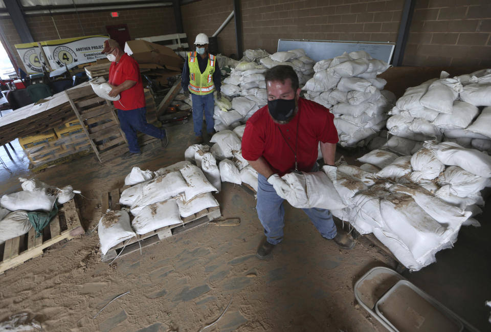 Tony Forina Hidalgo County Precinct 4 External Operations Director and other employees from the precinct load sand bags on Friday, July, 24, 2020, in Edinburg, Texas. Tropical Storm Hanna will bring heavy rain and flash flooding to deep South Texas. (Delcia Lopez/The Monitor via AP)