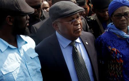 Congolese opposition leader Etienne Tshisekedi (C) is escorted upon arriving at the airport in the Democratic Republic of Congo's capital Kinshasa, July 27, 2016, after nearly two-year stay overseas for medical treatment. REUTERS/Kenny Katombe