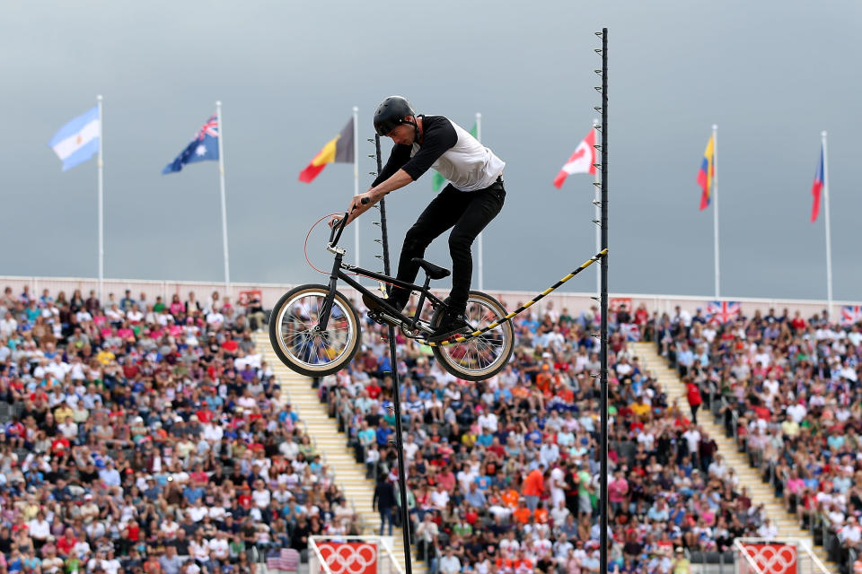 An exhibition rider jumps over a stick on Day 12 of the London 2012 Olympic Games at BMX Track on August 8, 2012 in London, England. (Getty Images)