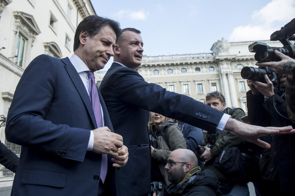 Italian Premier Giuseppe Conte, left, speaks to reporters about the regional elections in Emilia Romagna outside the premier's office Chigi palace, in Rome, Monday, Jan. 27, 2020. Italian voters thwarted right-wing opposition leader Matteo Salvini's hopes of turning an election in a key northern region into a springboard for regaining national power, nearly complete results showed Monday. (Roberto Monaldo/LaPresse via AP)