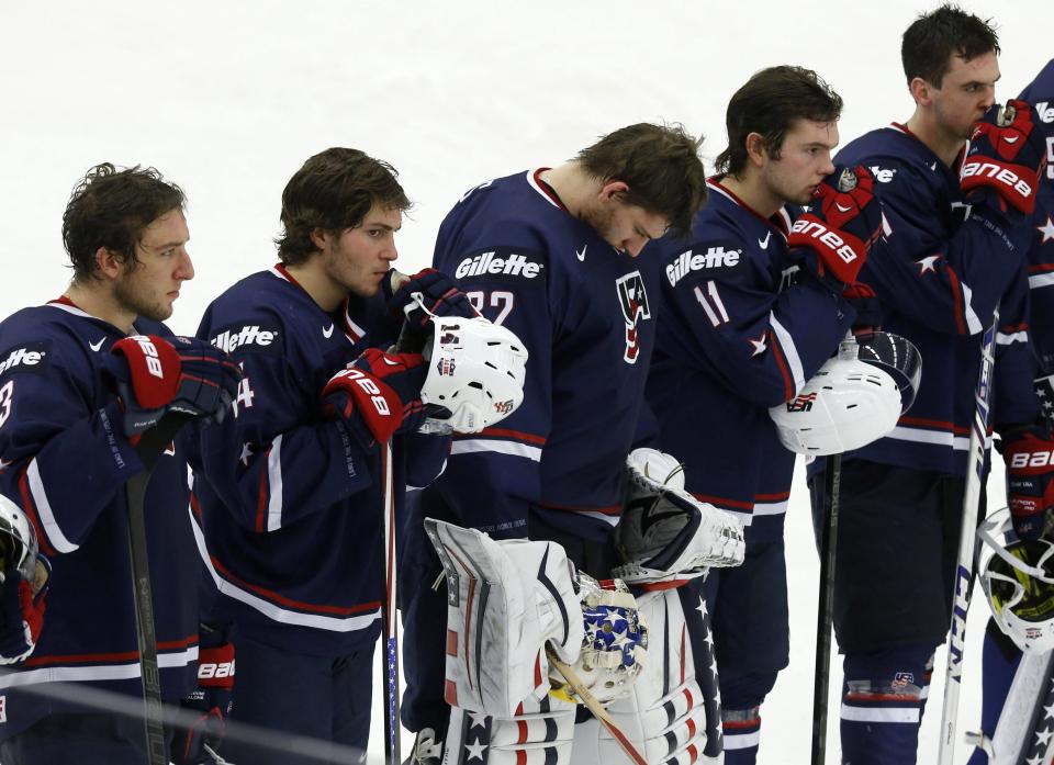 U.S. players react after their loss to Russia in their IIHF Ice Hockey World Championship quarter-final match in Malmo January 2, 2014. REUTERS/Alexander Demianchuk (SWEDEN - Tags: SPORT ICE HOCKEY)