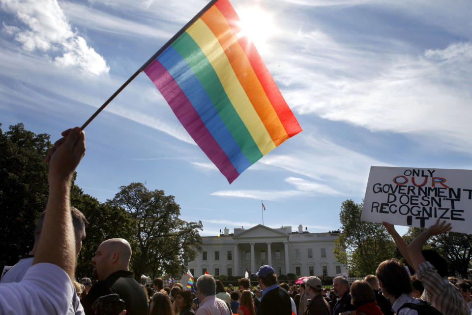 FILE - Gay rights advocates march by the White House in Washington, on Sunday, Oct. 11, 2009. President Joe Biden plans to sign legislation this coming week that will protect gay unions even if the Supreme Court revisits its ruling supporting a nationwide right of same-sex couples to marry. It's the latest part of Biden's legacy on gay rights, which includes his unexpected endorsement of marriage equality on national television a decade ago when he was vice president. (AP Photo/Jacquelyn Martin, File)