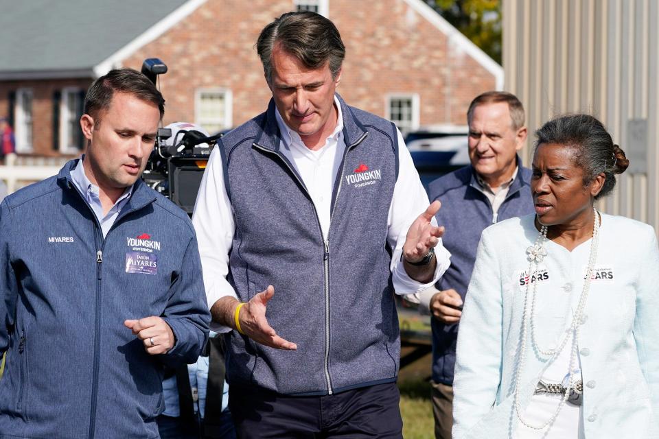 Republican gubernatorial candidate Glenn Youngkin, center, speaks with running mates, attorney general candidate, Jason Miyares, left, and lieutenant governor candidate Winsome Sears, right, as they walk from a rally in Fredericksburg, Va., . Youngkin will face Democrat former Gov. Terry McAuliffe in the November election Election 2021 Down Ballot Races, Fredericksburg, United States - 30 Oct 2021
