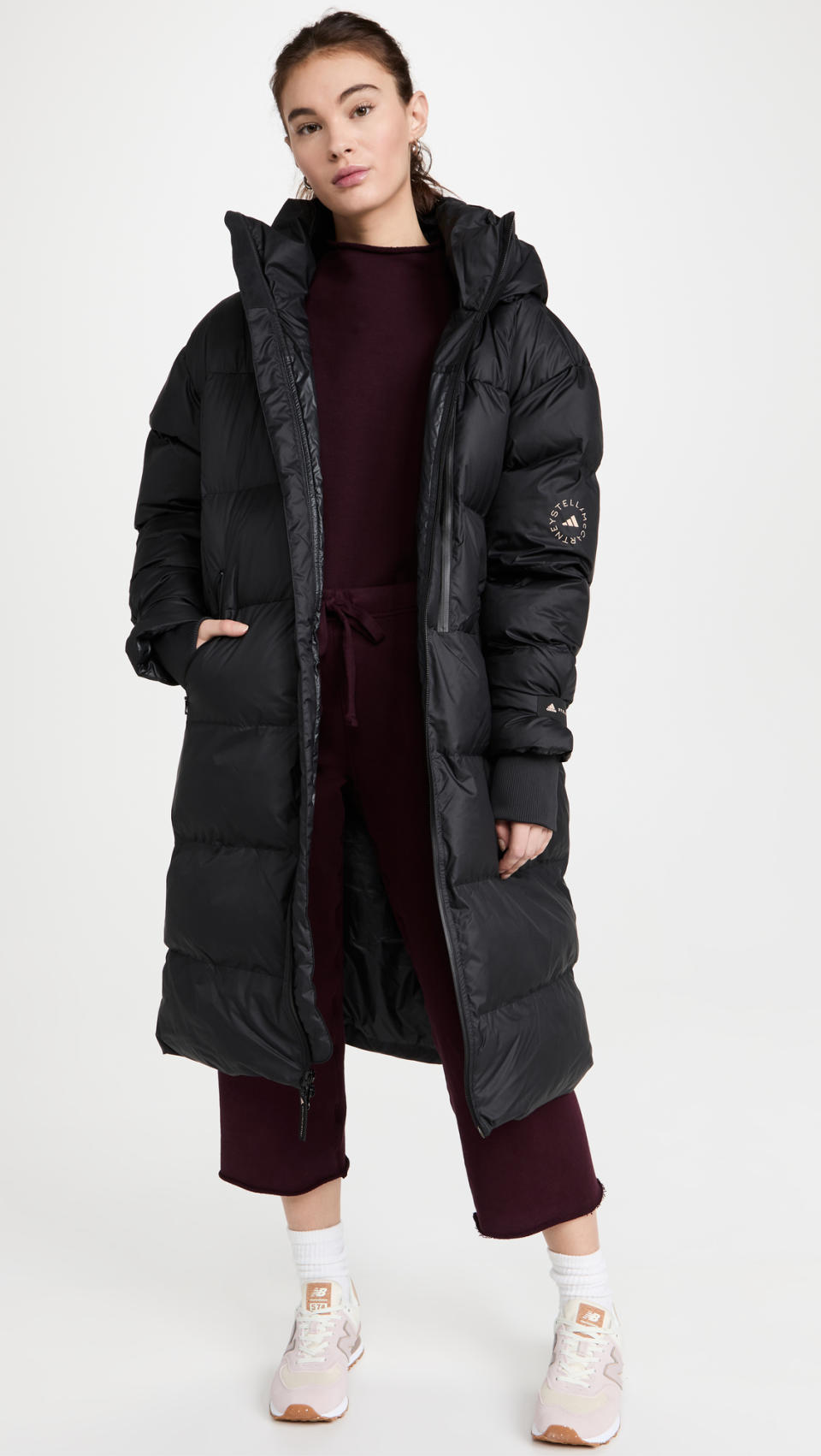 Model wears Adidas by Stella Mccartney Long Puffer Jacket in black