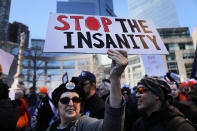 <p>Marchers wave signs in Manhattan. (Photo: Getty Images) </p>